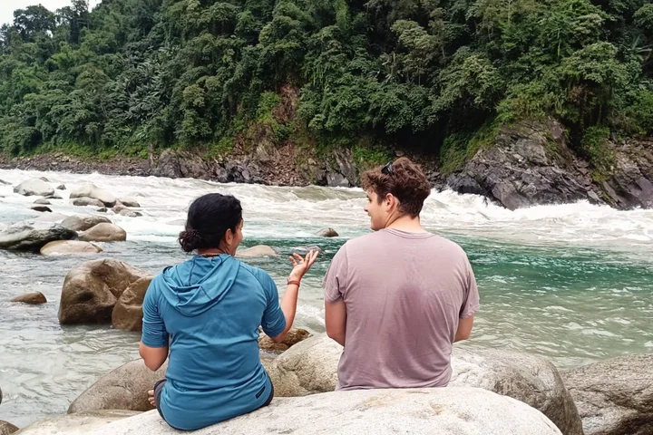 Couple standing together by the Ganga at dusk near Atali Ganga